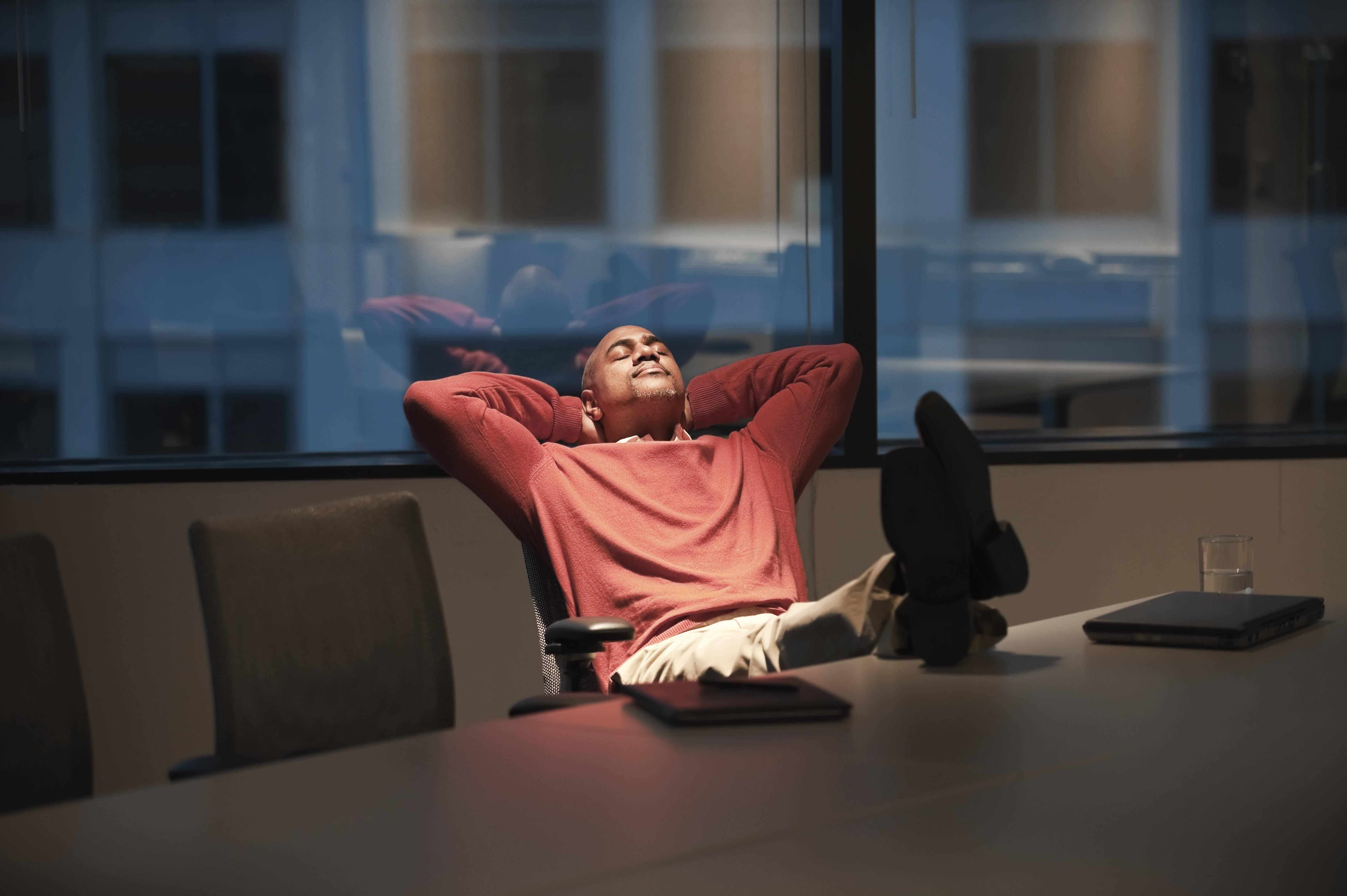 a-black-businessman-with-his-feet-up-on-a-desk-whi-2025-04-05-06-58-11-utc