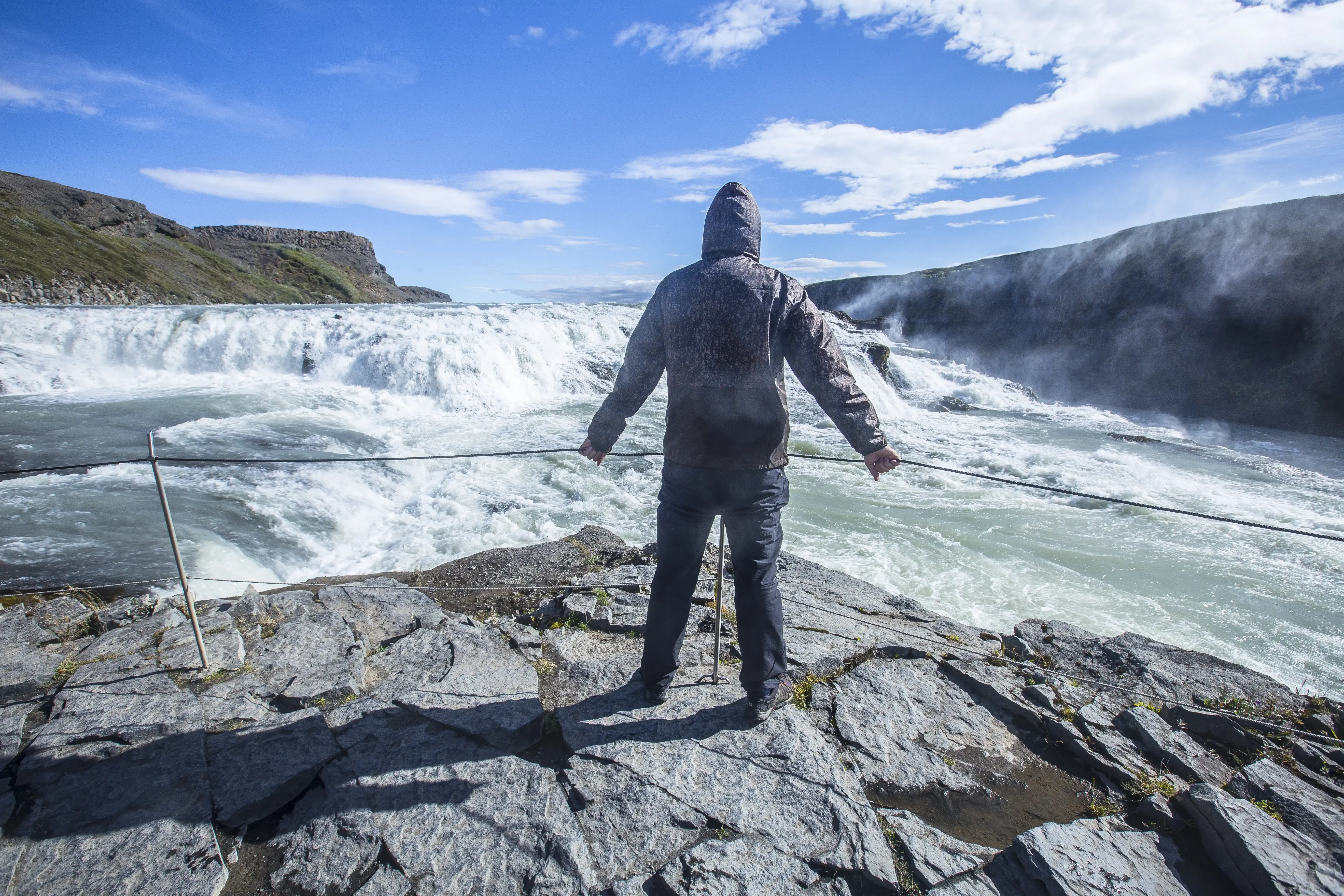 a-young-man-above-the-gullfoss-waterfall-in-the-go-2024-12-09-01-41-35-utc
