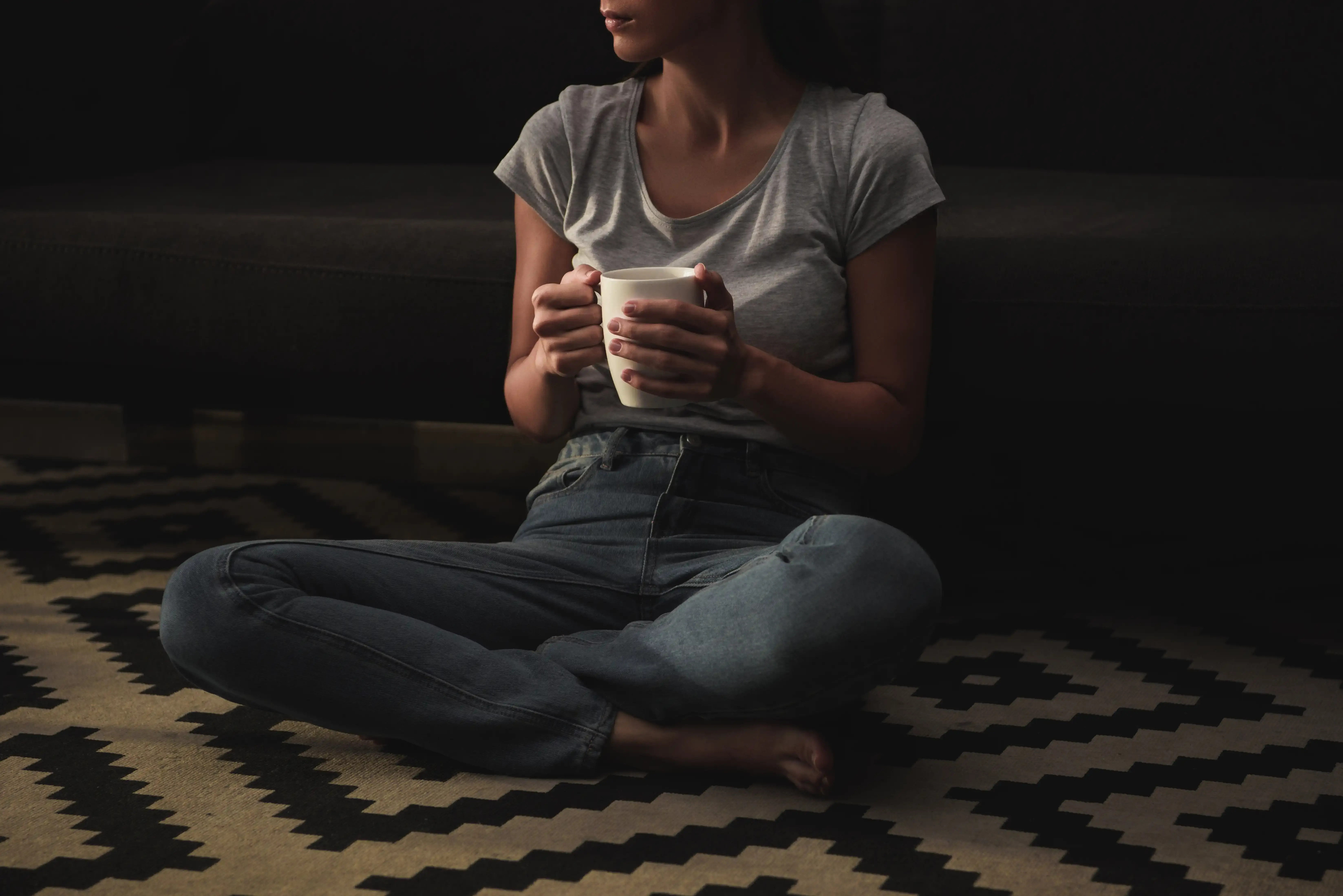 cropped-view-of-sad-woman-with-coffee-cup-sitting-2024-11-17-09-58-37-utc