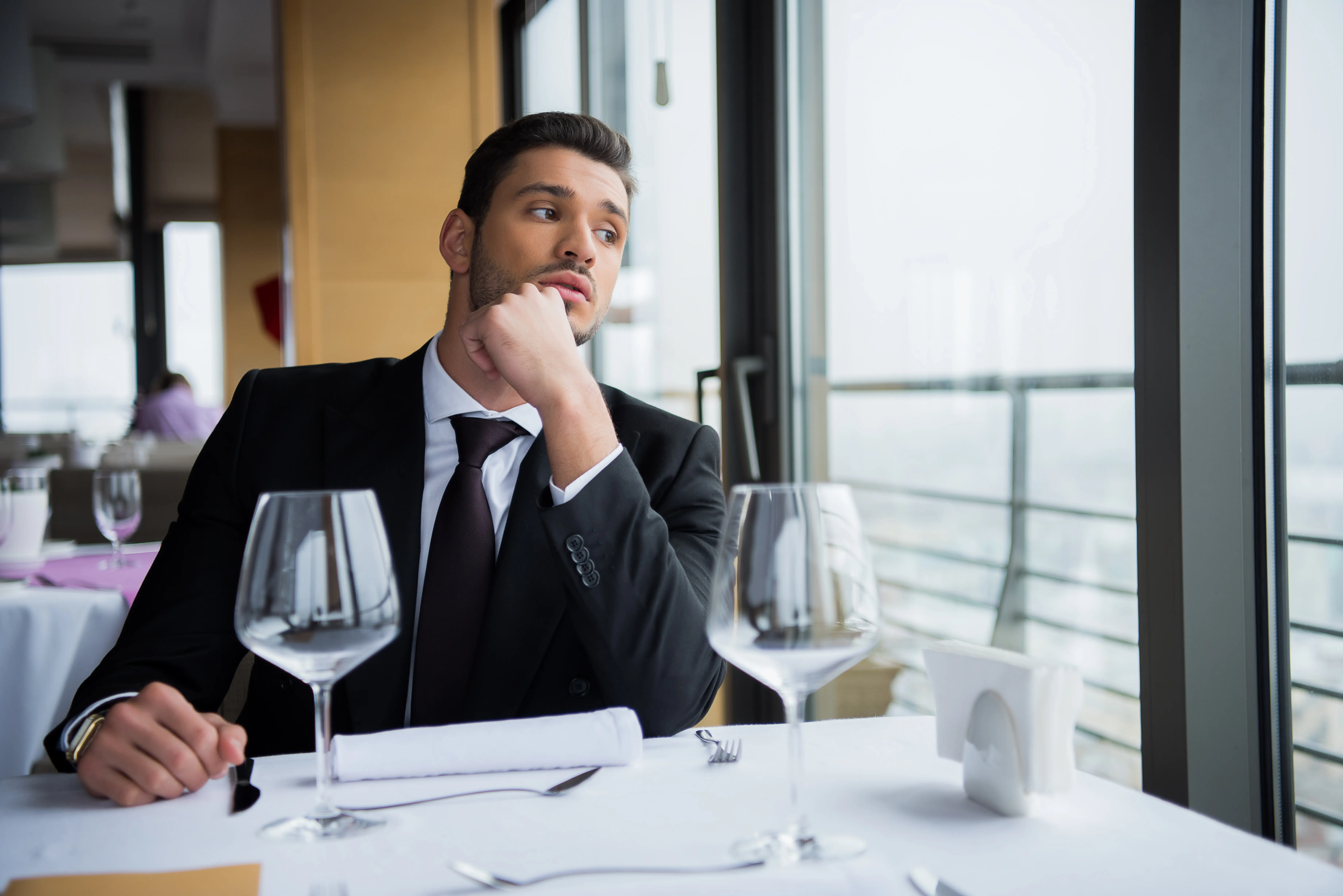 pensive-man-in-suit-looking-away-while-waiting-for-2024-11-08-11-19-52-utc