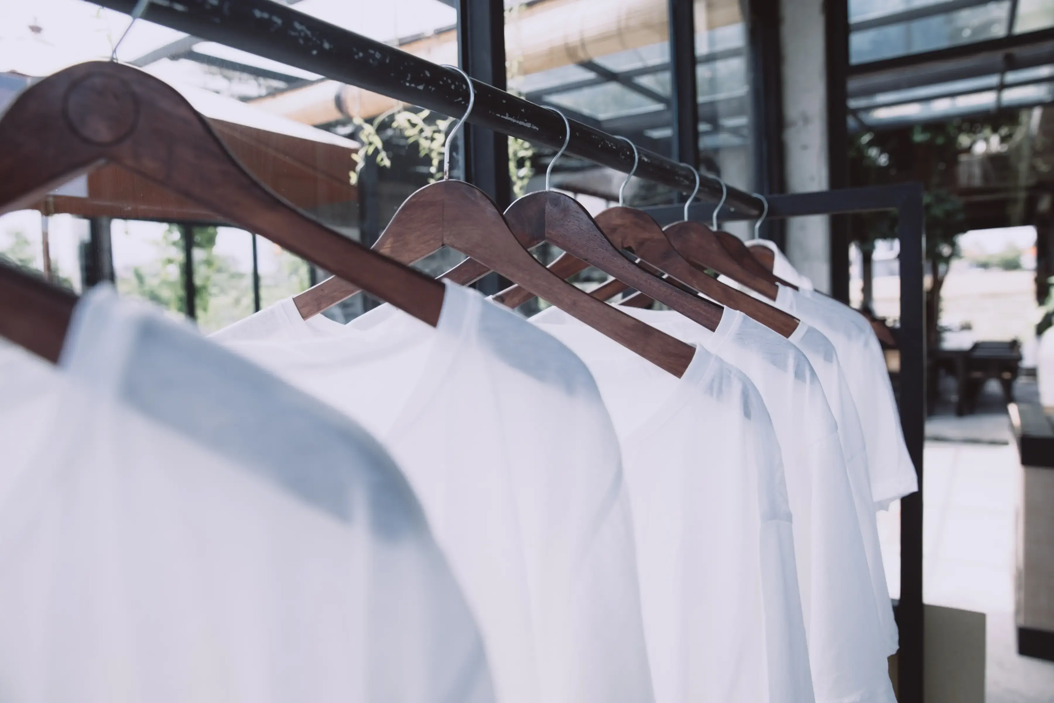 rail-with-white-t-shirts-on-hangers-in-the-store-2025-02-21-07-46-14-utc