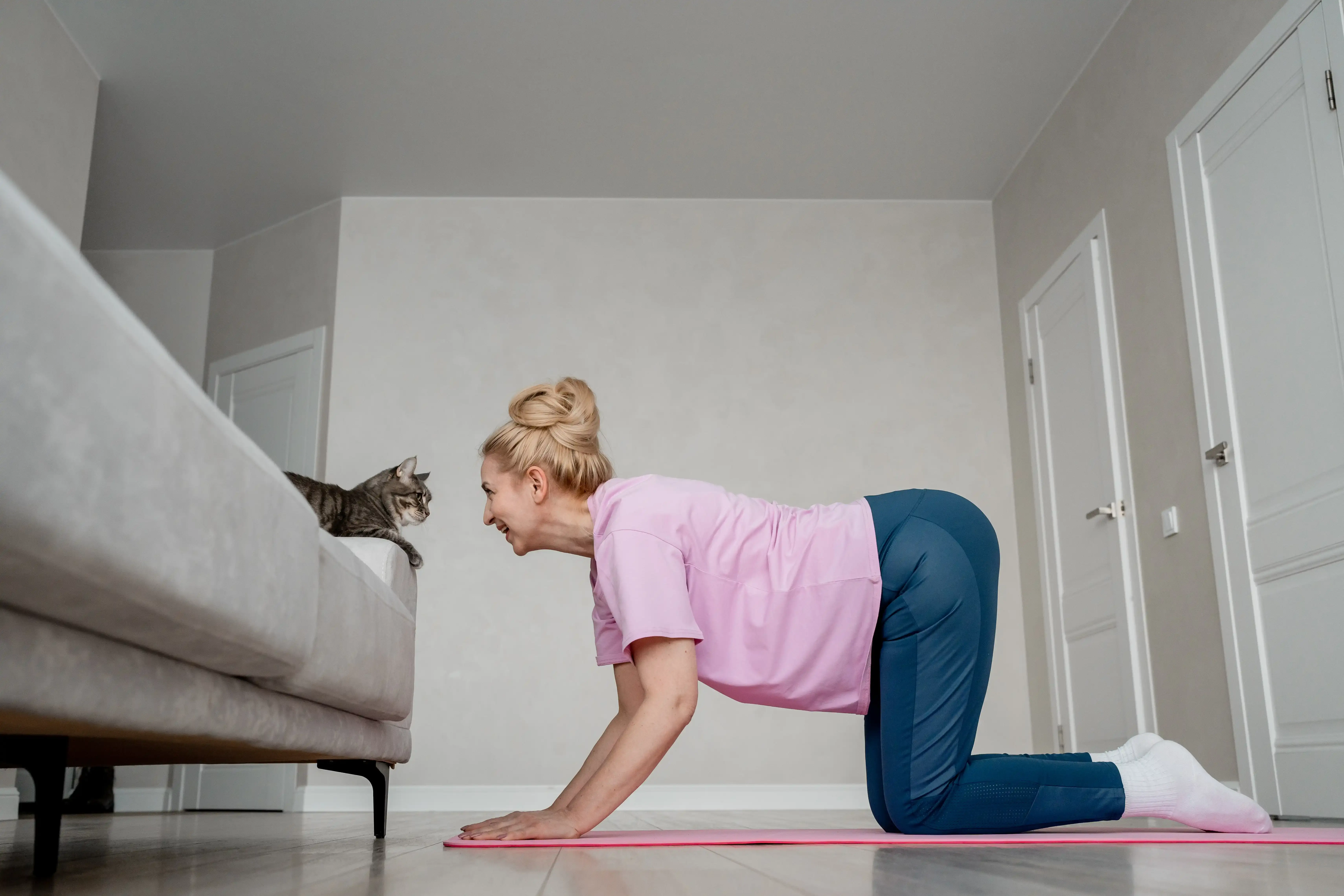 woman-at-home-with-her-cat-practicing-yoga-togeth-2024-12-07-23-20-47-utc