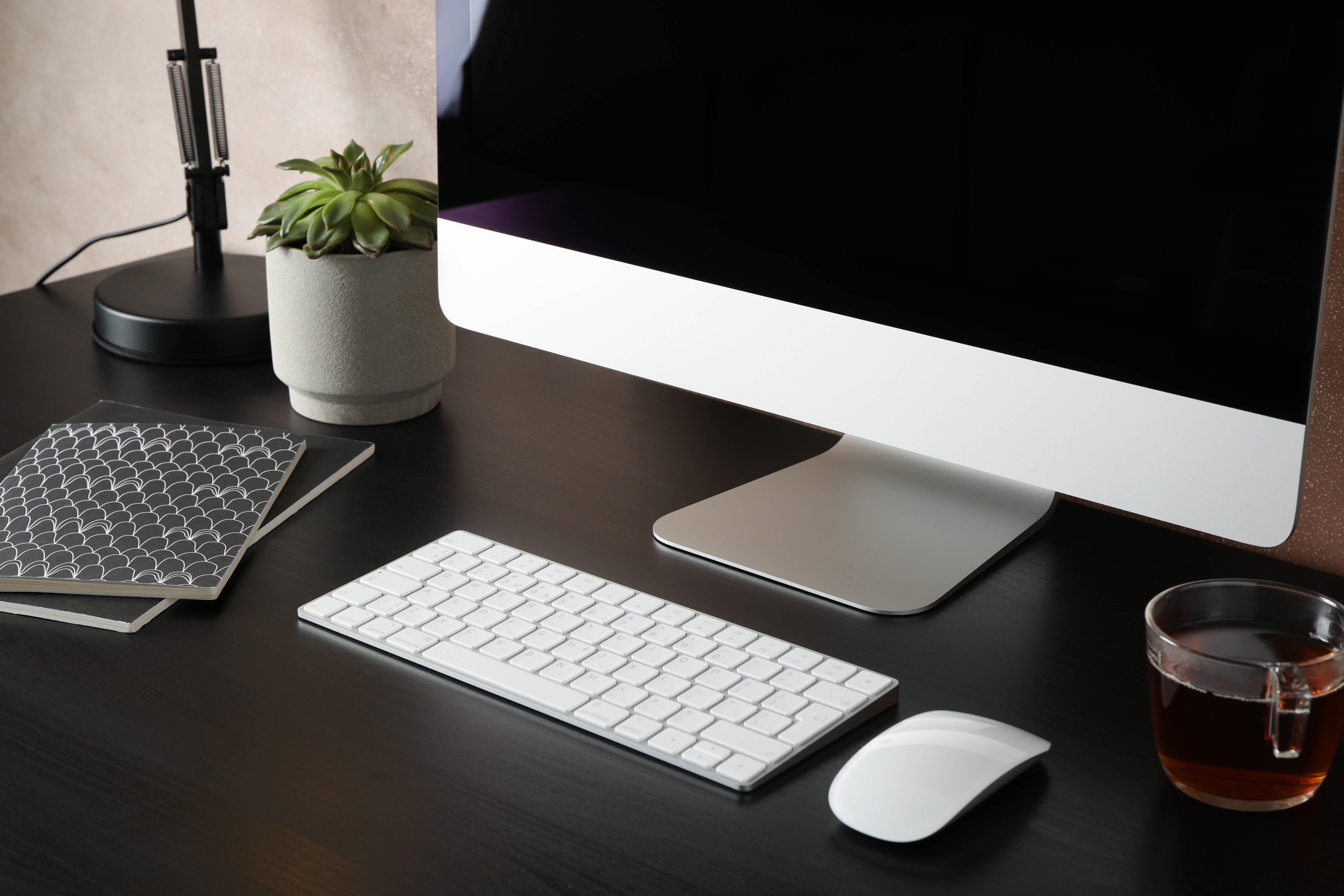 workplace-with-computer-cup-of-tea-and-plant-on-b-2025-03-26-21-58-23-utc