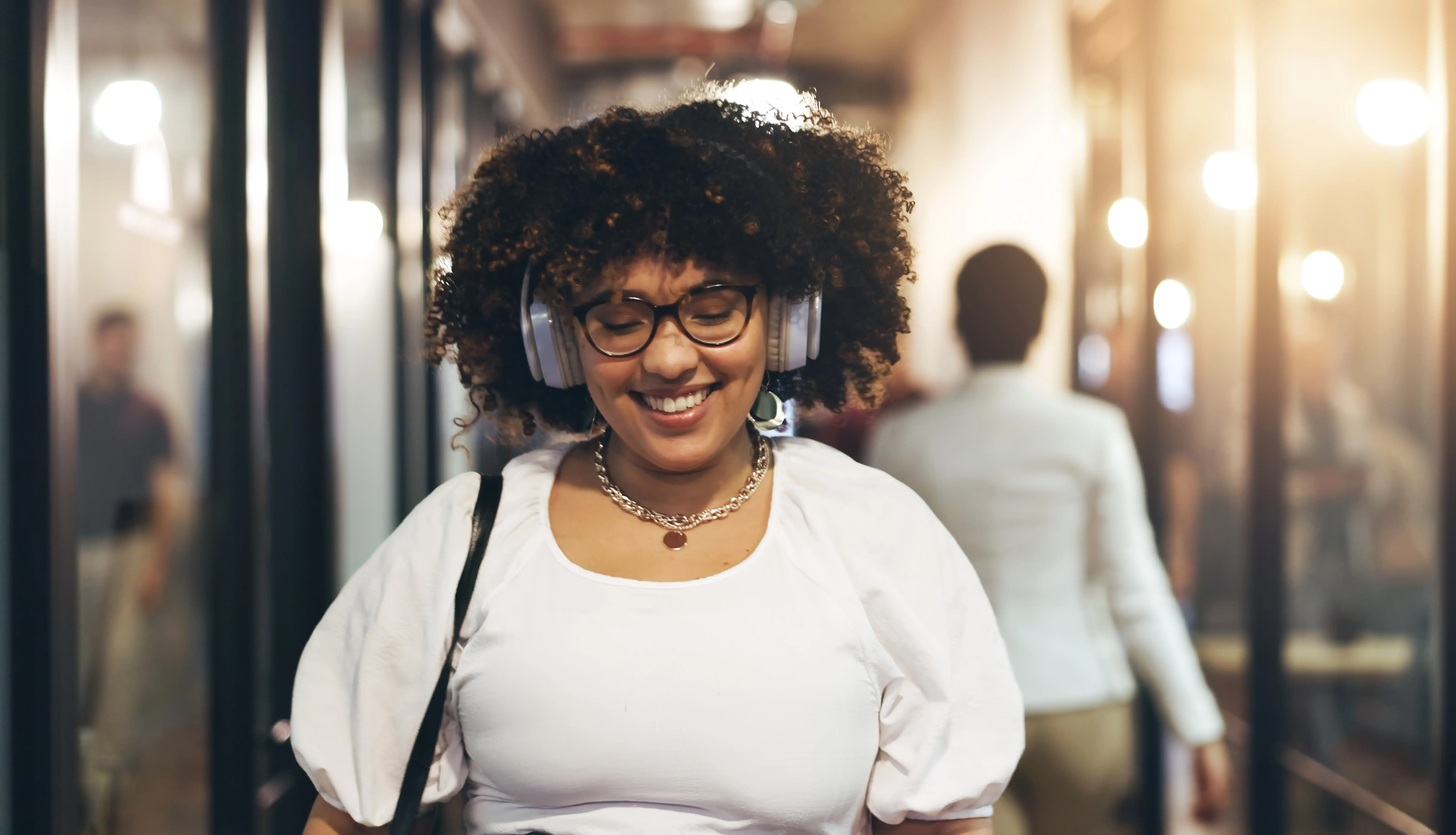 headphones-happy-and-face-of-a-woman-in-the-offic-2025-04-06-11-52-20-utc.webp