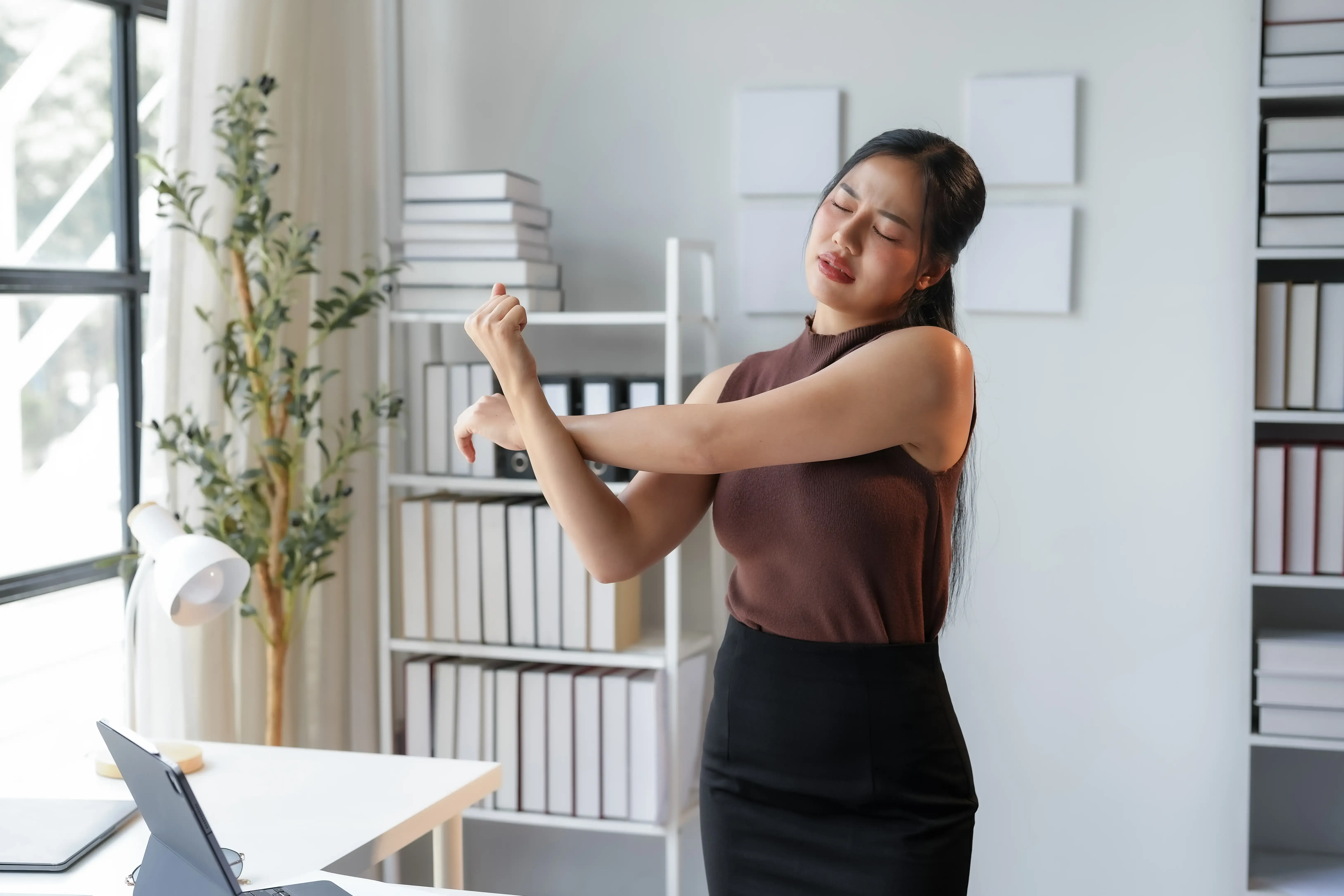 young-office-manager-is-relieving-muscle-tension-b-2025-03-09-06-38-22-utc.webp